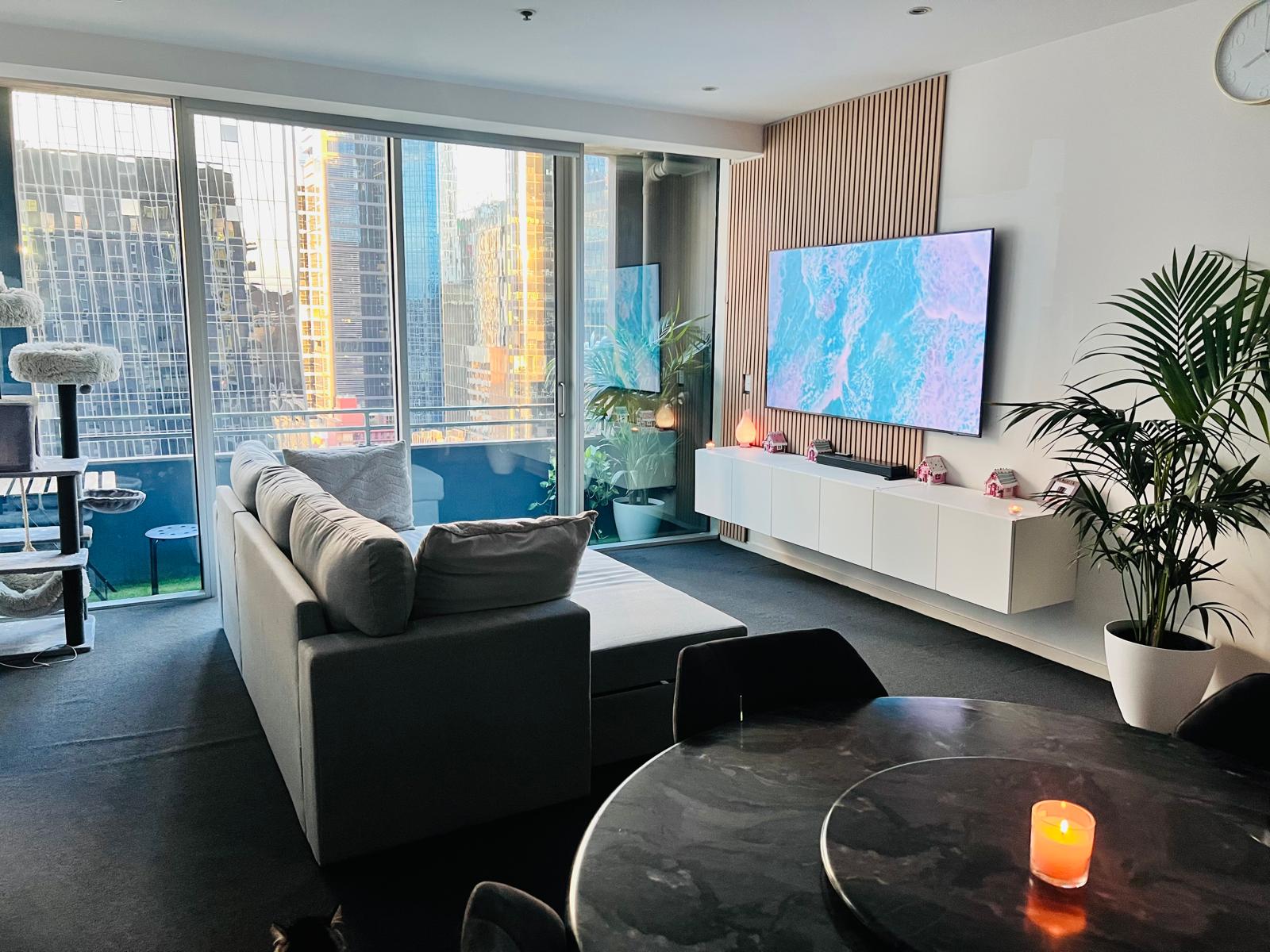 Living room with floor-to-ceiling city views